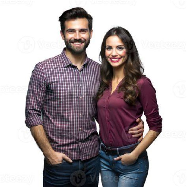 a man and woman standing next to each other on a city street with