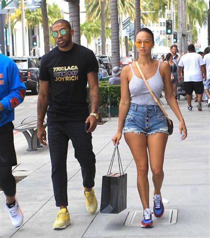 Draya Michele and fianc&eacute; Orlando Scandrick share a kiss at Miami Swim
