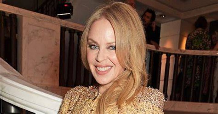 Kylie Minogue, 52, puts on a leggy display in clinging leather mini