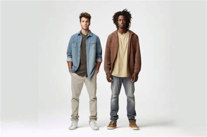 two men standing next to each other in shorts